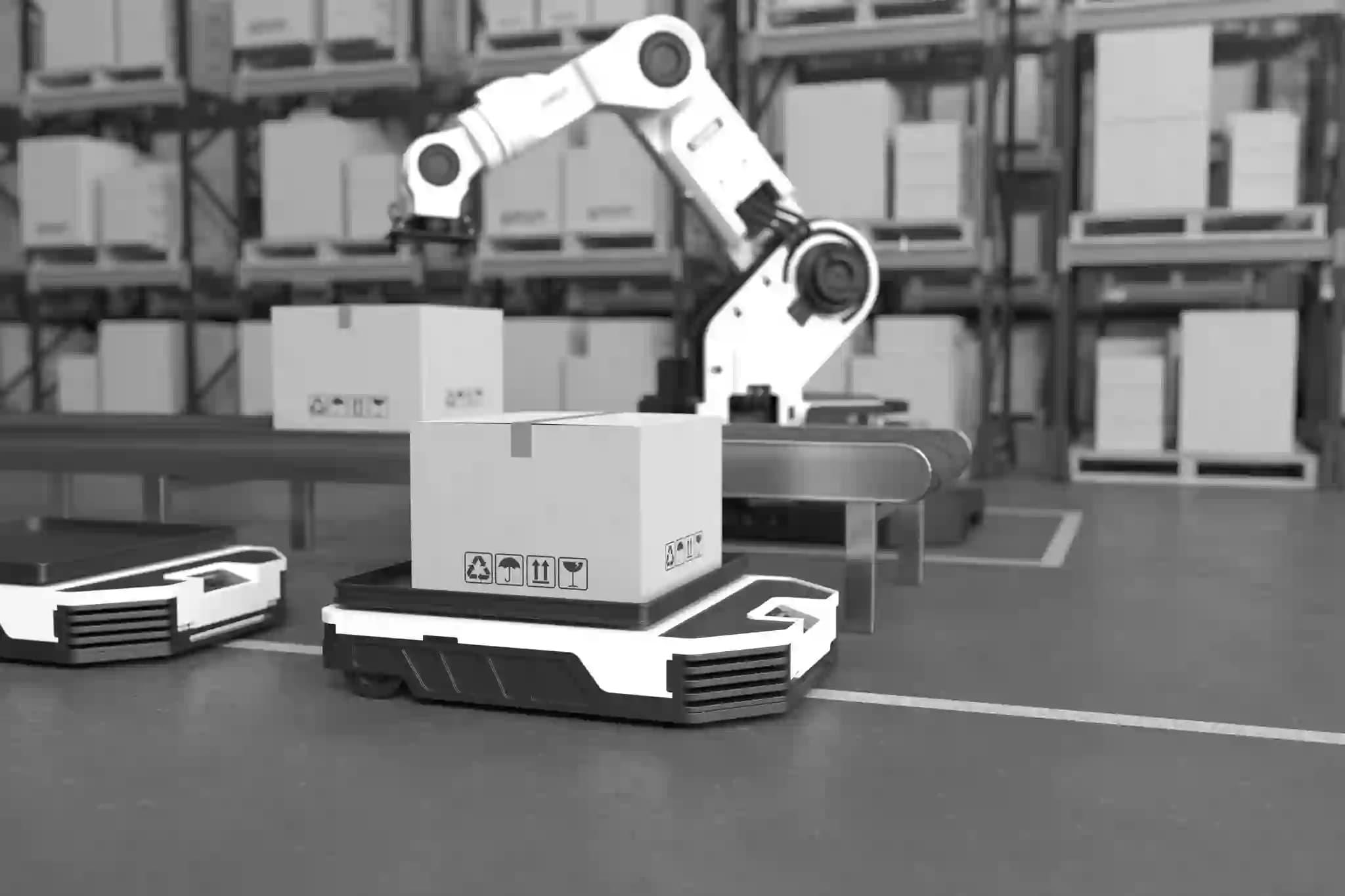 A robotic arm places a box onto an autonomous mobile robot in a warehouse